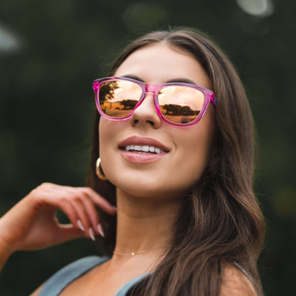 A woman wearing Epoch LXE - Polarized Sunglasses while cycling.